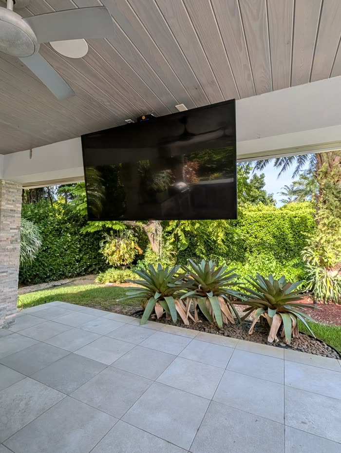 Finished install, ceiling-mounted TV on covered patio