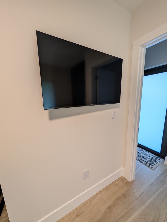 Finished install, TV mounted on wall by entryway